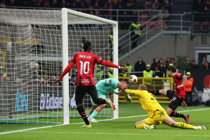 Rafael Leao pictured (left) watching on as Christian Pulisic (right) volleys the ball into the net to score for AC Milan in a 4-2 win over Slavia Prague in March 2024